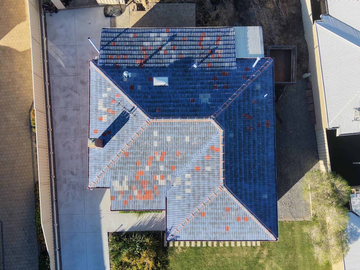 Roof before restoration, faded and patchy tiles