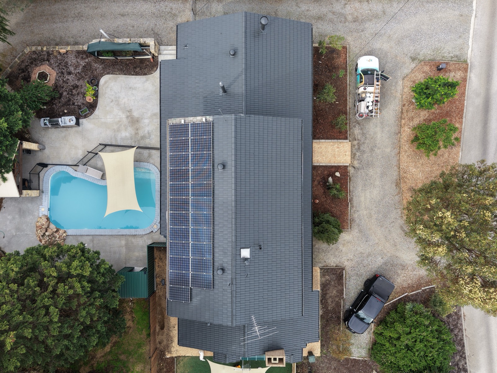 Roof after HydroFlow restoration, clean charcoal finish with solar panels