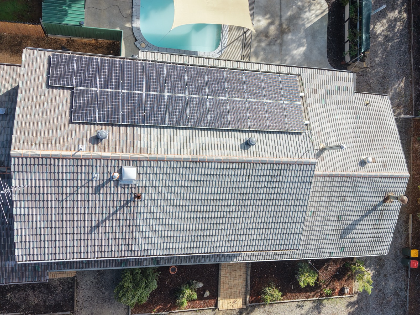 Roof before restoration, dirty and weathered tiles with solar panels