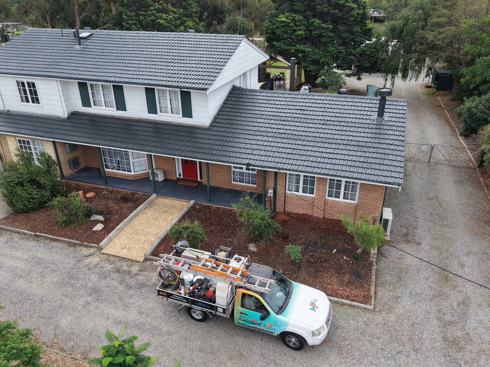 HydroFlow work truck parked at a completed roof restoration job in Perth