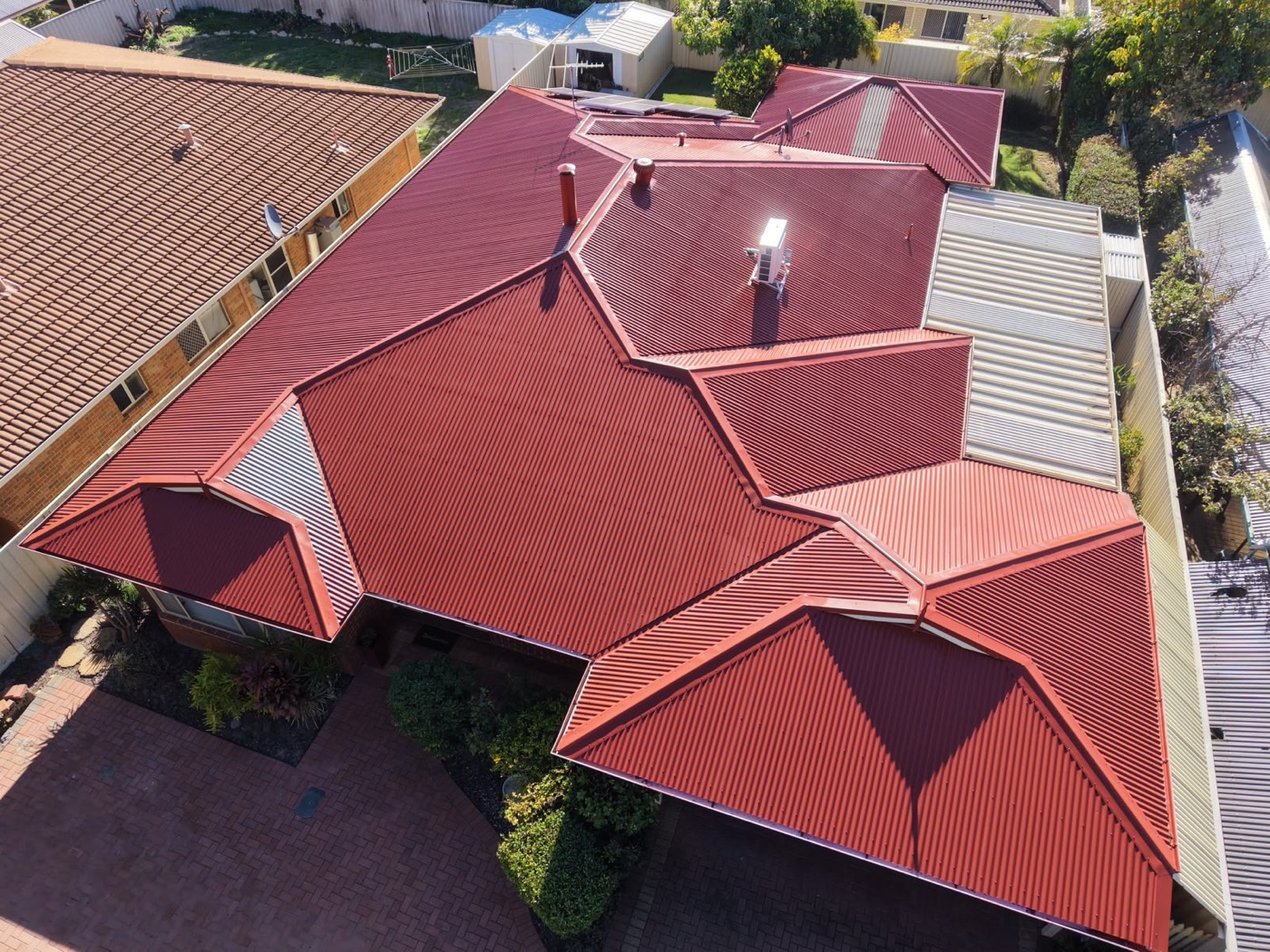 Terracotta roof after HydroFlow restoration, vibrant fresh red finish