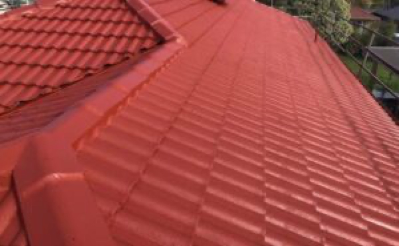 Close up of a restored terracotta red tiled roof