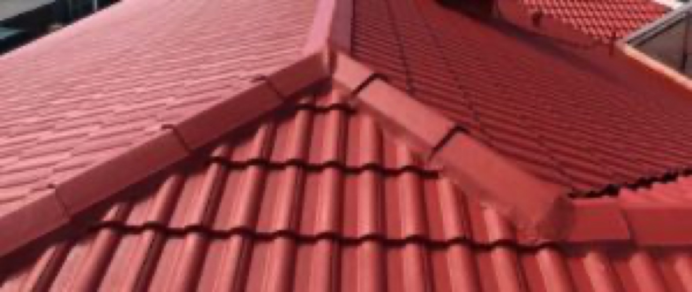 Restored red tiled roof ridge line